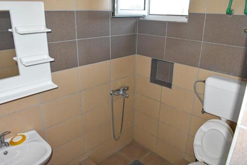 a bathroom with a shower and a toilet and a sink at Apartments Murati in Ulcinj