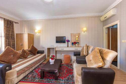 a living room with a couch and a table at Ista Palace Hotel in Istanbul