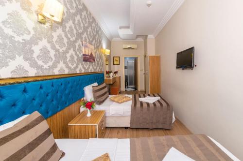 a hotel room with a bed and a tv at Ista Palace Hotel in Istanbul