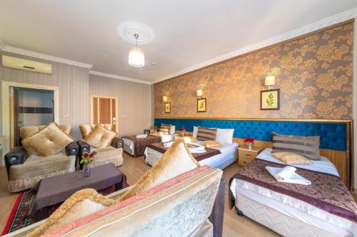 a hotel room with four beds and a living room at Ista Palace Hotel in Istanbul