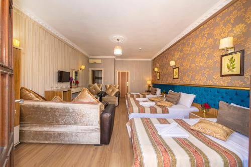 a hotel room with four beds and a couch at Ista Palace Hotel in Istanbul