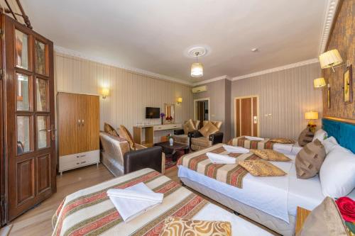 a hotel room with two beds and a living room at Ista Palace Hotel in Istanbul