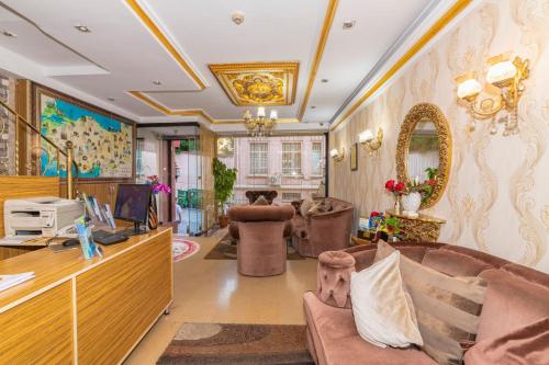 a living room with a couch and a desk at Ista Palace Hotel in Istanbul