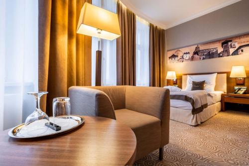 a hotel room with a table and a bed at Hotel Elizabeth in Trenčín