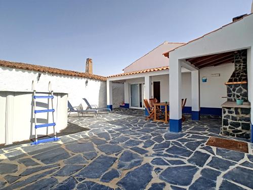 a stone patio with a fireplace in a house at Casa Refugio Do Campo in Reguengos de Monsaraz