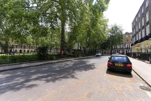 a black car parked on the side of a street at KX Rooms Kings Cross in London
