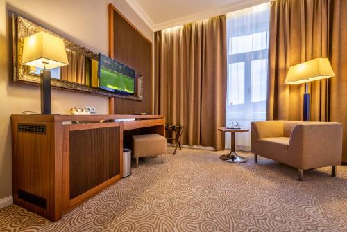 a hotel room with a television and a desk and a chair at Hotel Elizabeth in Trenčín