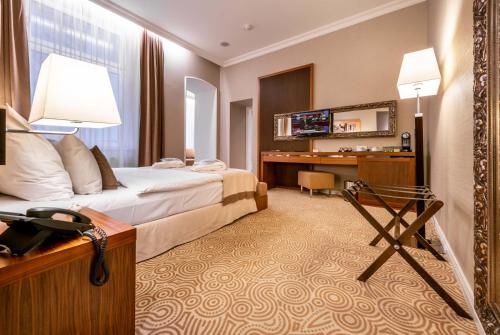 a hotel room with a bed and a desk at Hotel Elizabeth in Trenčín