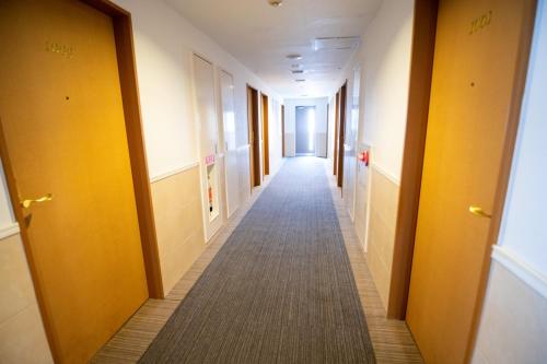a hallway of an office building with a long corridor at AZ Inn Handa Inter in Handa