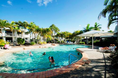 a group of people in the swimming pool at a resort at Ivory Palms Resort Noosa in Noosaville