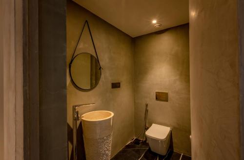 a bathroom with a toilet and a mirror at Radisson Resort and Spa Lonavala in Lonavala