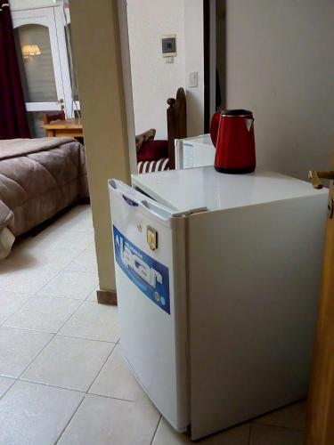 a refrigerator with a red appliance sitting on top of it at La Casona de Susana in Colón