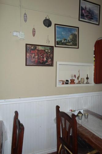 a dining room with a table and some pictures on the wall at La Casona de Susana in Colón