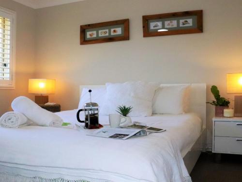 A bed or beds in a room at White Sands @ Fingal Bay