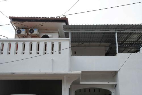 a white building with a speaker on top of it at RedDoorz near GOR Jatidiri Semarang in Jatingaleh
