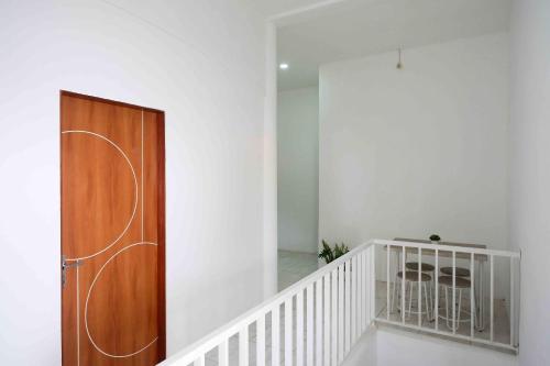a staircase with a wooden door in a room at RedDoorz near GOR Jatidiri Semarang in Jatingaleh