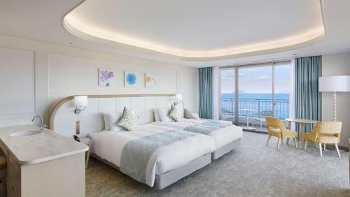 a hotel room with a large bed and a balcony at Karatsu Seaside Hotel in Karatsu