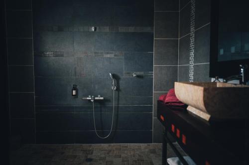 a bathroom with a shower and a sink at Hotel Hibiscus in Koné