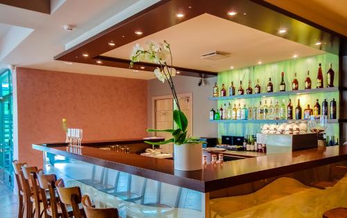 a bar in a restaurant with a lot of bottles at Hotel Tigra in Priekuļi