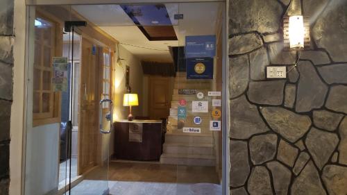 a hallway in a building with a stone wall at Sehrish Guest House Skardu in Skardu