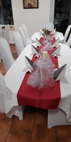 a long table with a red and white table cloth at Soukromá rezidence Pohádková usedlost Lovětín in Lovětín
