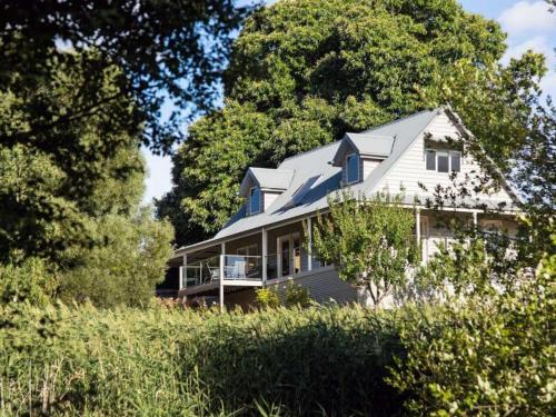a large white house with a porch and trees at Della Fonte- rural oasis, Daylesford charm in Daylesford