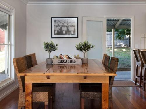 a dining room with a wooden table and chairs at Della Fonte- rural oasis, Daylesford charm in Daylesford