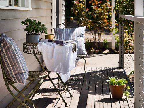 a table and chairs on a porch with plants at Haiku - charming oasis in Daylesford in Daylesford