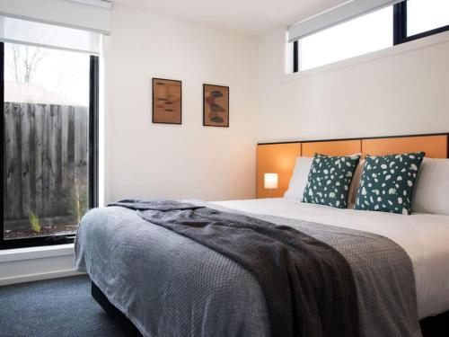 a bedroom with a large bed and a window at Arenas North in Daylesford