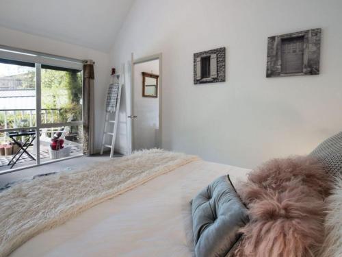 a bedroom with a bed with a furry pillow on it at Cottage 4A in Daylesford