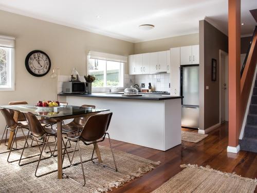 a kitchen and dining room with a table and chairs at Accolade -3 bedroom, close to Lake Daylesford in Daylesford