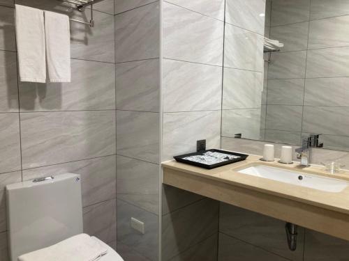 a bathroom with a white toilet and a sink at Hotel A in Tainan