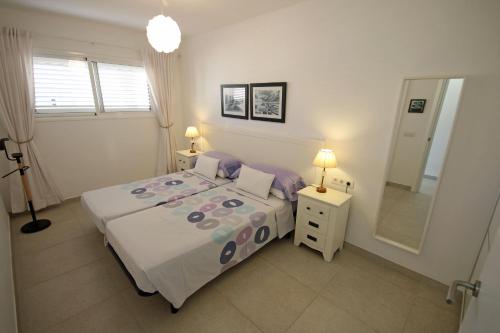 sypialnia z łóżkiem i dużym lustrem w obiekcie MARINEDA by RENTMEDANO newly renovated, ocean view, wifi, parking, pool w mieście El Médano