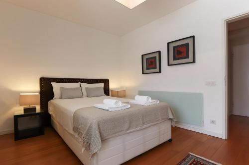 a bedroom with a bed with two towels on it at Downtown Chiado by Homing in Lisbon