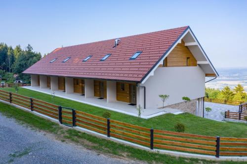 a rendering of a house with a red roof at Apartmaji Hočka Koča in Pohorje