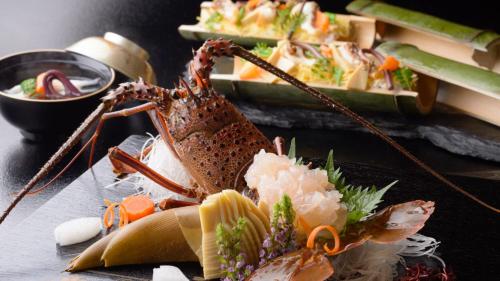 a lobster on a plate of food with sushi at Hotel Isago Kobe in Kobe