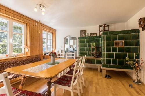 a dining room with a wooden table and chairs at Der Lachenbuckhof in Blumberg