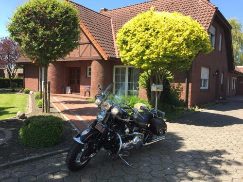 a motorcycle parked in front of a house at Ferienwohnung Vereinswiek 95137 in Rhauderfehn