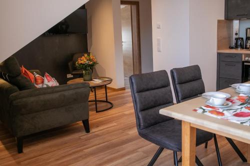 a living room with a table and two chairs at Ferienhof Naderhirn - Bauernhof in Wegscheid