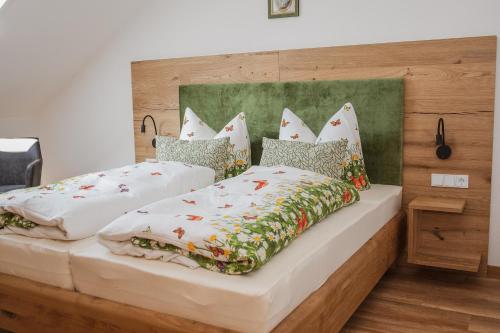 a bedroom with two beds with pillows at Ferienhof Naderhirn - Bauernhof in Wegscheid