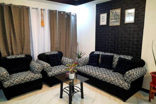 a living room with two couches and a table at Jan's Haven Staycation House Deca Clark Angeles in Angeles