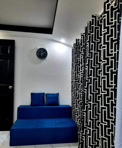 a room with two blue beds and a wall with a pattern at Jan's Haven Staycation House Deca Clark Angeles in Angeles