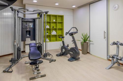 a gym with treadmills and exercise equipment in a room at Melia Luxembourg in Luxembourg
