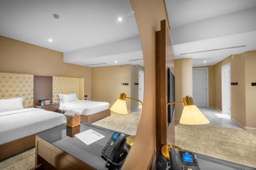 a hotel room with two beds and a camera at Suknai Royal Hotel in Hail