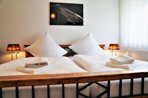 a bed with two towels on top of it at Zimmer for you in Rösrath