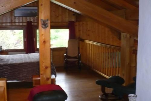 a bedroom with a bed in a wooden cabin at Le chalet de Julbert in Combloux
