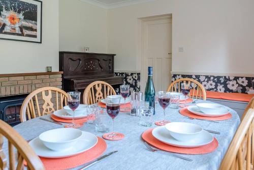 a table with plates and wine glasses on it at The Spinney Saxtead nr Framlingham in Woodbridge