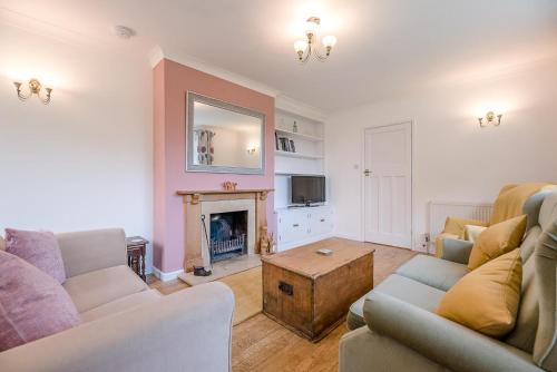 a living room with two couches and a fireplace at The Spinney Saxtead nr Framlingham in Woodbridge