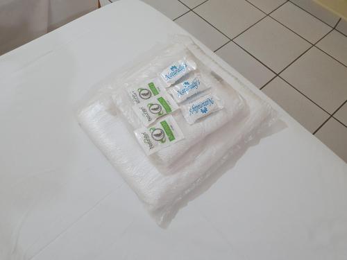 a package of toilet paper sitting on a bathroom floor at JF Flat - Hotel in Ribeirão Preto