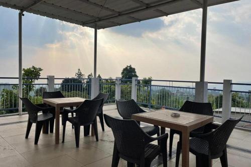 a group of tables and chairs on a patio at Villa Syariah Citeko Mitra RedDoorz in Bogor